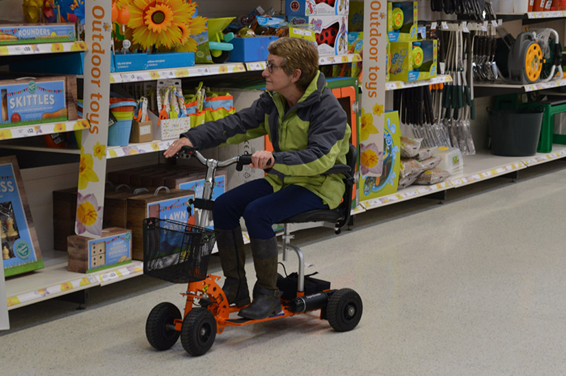 Customer on her SupaScoota in a supermarket Customer on her SupaScoota in a supermarket